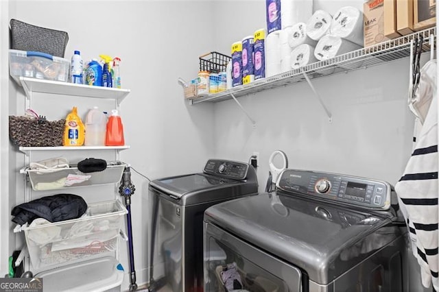 washroom with washing machine and clothes dryer