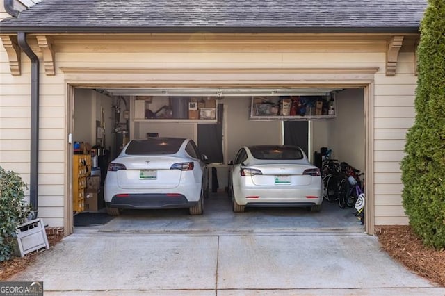 garage featuring concrete driveway