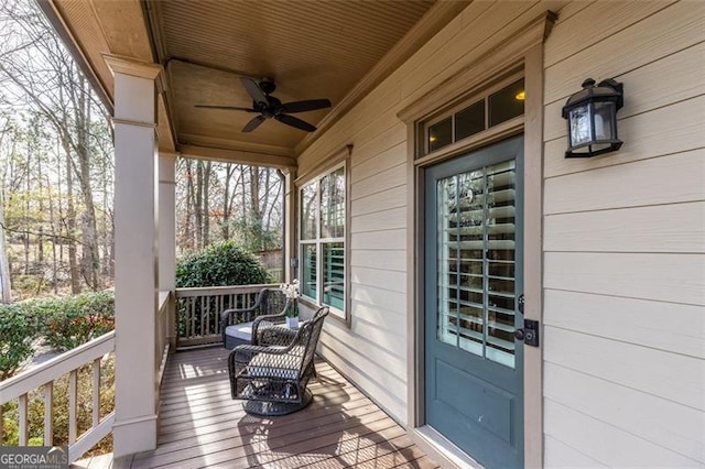 wooden deck featuring ceiling fan and a porch