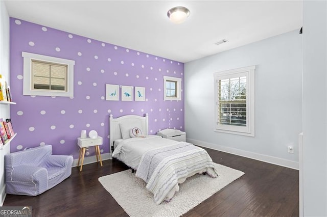 bedroom with dark wood-type flooring