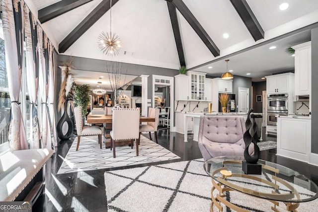 living room featuring sink, beam ceiling, high vaulted ceiling, and a notable chandelier