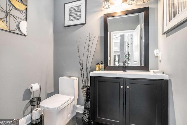 bathroom with toilet and vanity