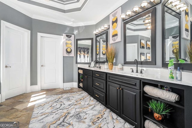 bathroom with vanity, ornamental molding, and a raised ceiling