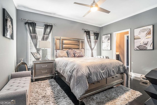 bedroom with ceiling fan, ensuite bath, hardwood / wood-style flooring, and crown molding