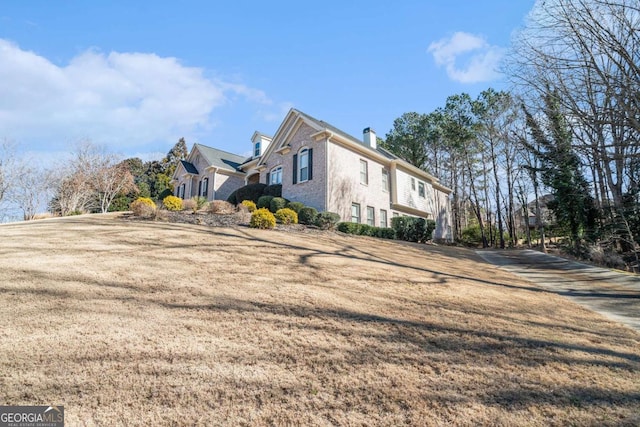 view of side of home featuring a lawn