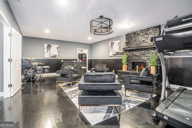 living room featuring hardwood / wood-style flooring, an inviting chandelier, and a fireplace