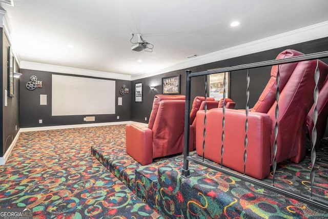 carpeted cinema room featuring crown molding