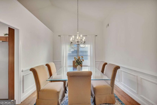 dining room with an inviting chandelier and light hardwood / wood-style flooring