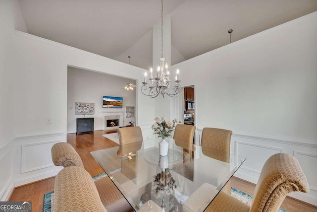 dining space featuring lofted ceiling, a notable chandelier, and hardwood / wood-style flooring