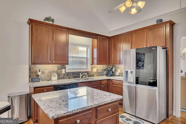 kitchen with a kitchen island, sink, black dishwasher, stainless steel fridge with ice dispenser, and light stone counters