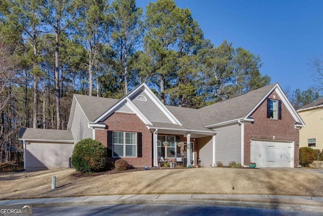 front facade featuring covered porch and a garage