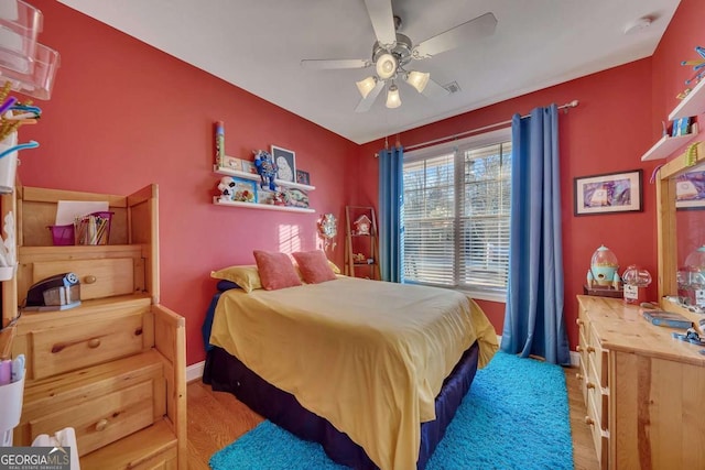 bedroom with ceiling fan and light hardwood / wood-style flooring