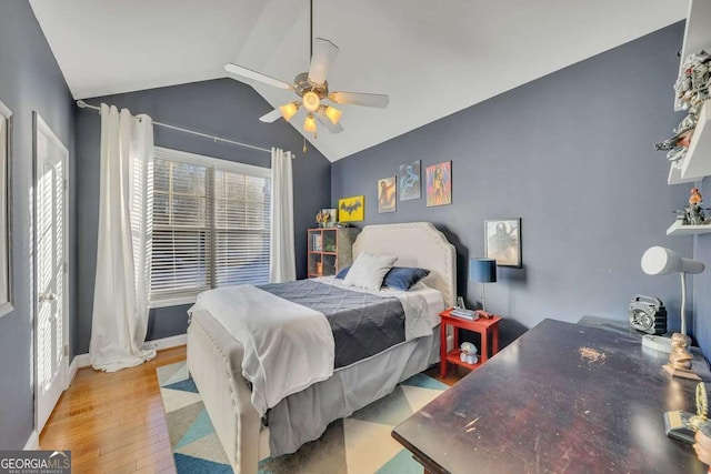 bedroom with vaulted ceiling, ceiling fan, and light hardwood / wood-style flooring