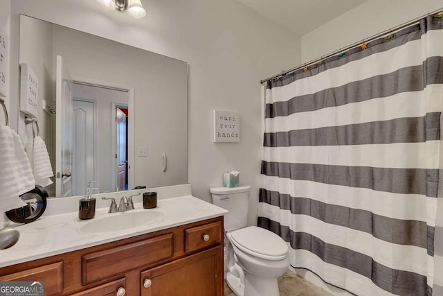 bathroom with toilet, tile patterned flooring, and vanity