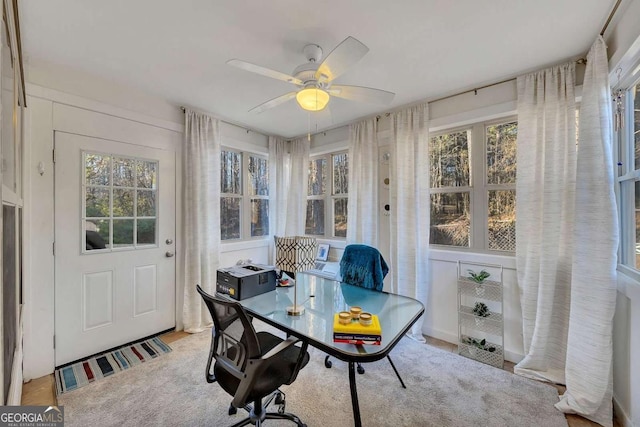 office featuring light carpet and ceiling fan