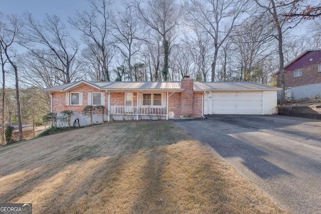 ranch-style home featuring a garage, a front yard, and a porch