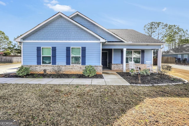 craftsman inspired home with covered porch and a front yard