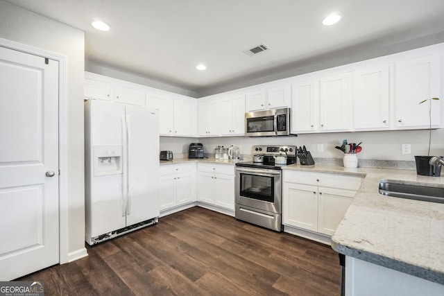 kitchen featuring stainless steel appliances, dark hardwood / wood-style flooring, white cabinetry, and sink