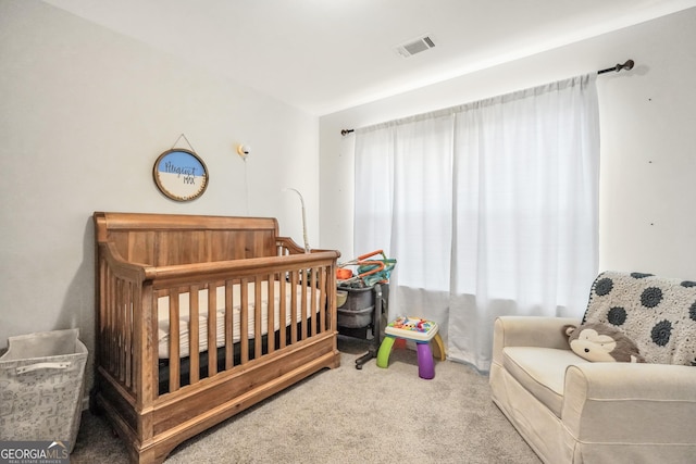 bedroom featuring carpet floors, multiple windows, and a nursery area