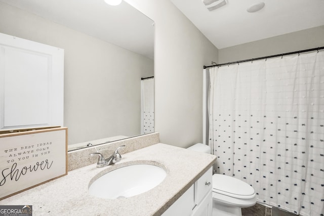 bathroom featuring toilet and vanity