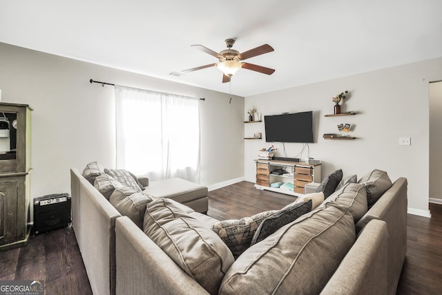 living room featuring ceiling fan and dark hardwood / wood-style floors