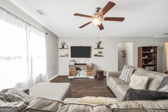 living room with ceiling fan and dark hardwood / wood-style floors