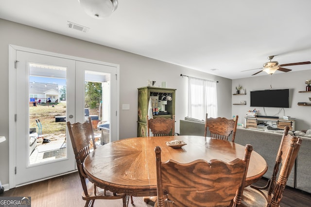 dining space with ceiling fan, french doors, and dark wood-type flooring