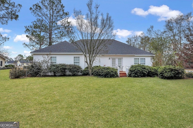 back of property featuring french doors and a yard