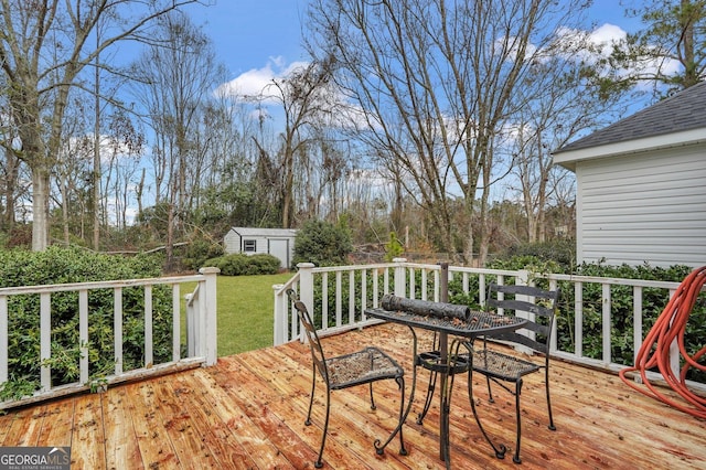 wooden deck featuring a storage unit and a yard