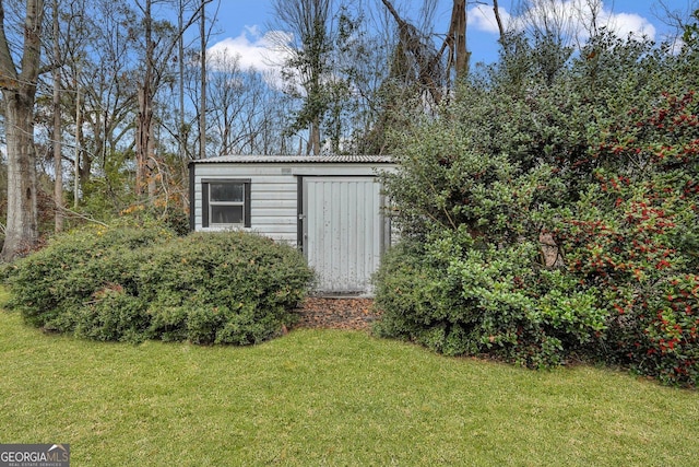 view of outbuilding with a yard