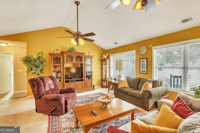 living room featuring a wealth of natural light, light carpet, and vaulted ceiling