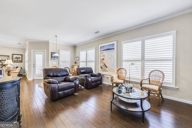 living room featuring hardwood / wood-style flooring, visible vents, and ornamental molding