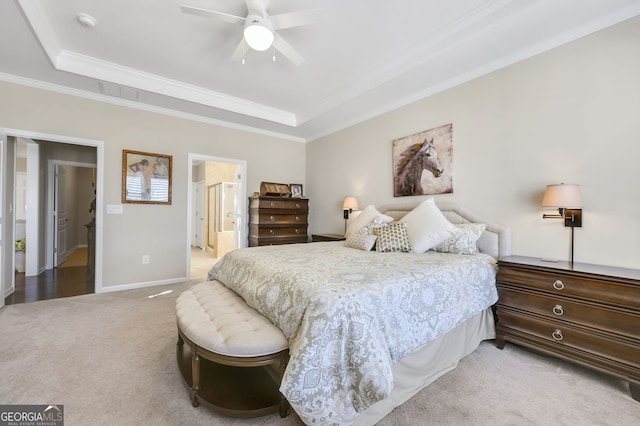 bedroom with baseboards, a tray ceiling, crown molding, and light colored carpet