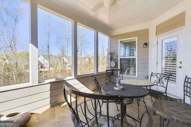 sunroom / solarium featuring ceiling fan