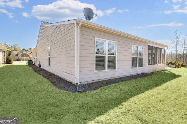 view of side of home featuring a lawn