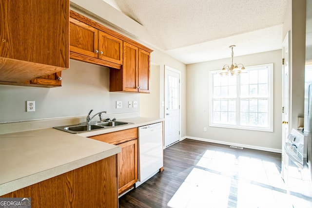 kitchen featuring decorative light fixtures, dishwasher, a textured ceiling, a chandelier, and sink