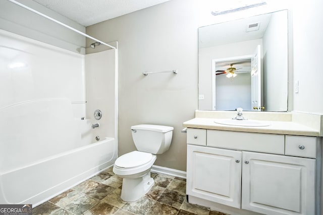 full bathroom featuring ceiling fan, vanity, toilet, tub / shower combination, and a textured ceiling