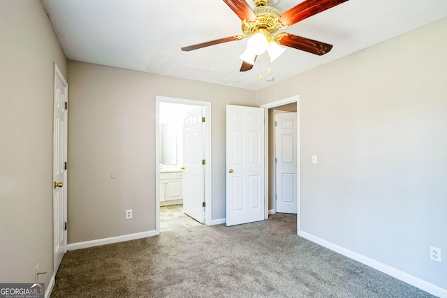 unfurnished bedroom with ceiling fan, light carpet, and ensuite bathroom