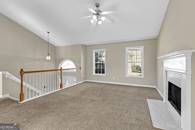 unfurnished living room featuring ceiling fan, carpet, lofted ceiling, and a premium fireplace