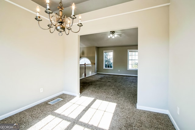 unfurnished dining area featuring ceiling fan with notable chandelier and carpet flooring