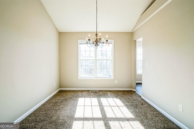 unfurnished dining area featuring carpet flooring, a chandelier, and vaulted ceiling