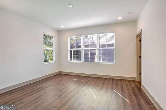 empty room featuring dark wood-type flooring