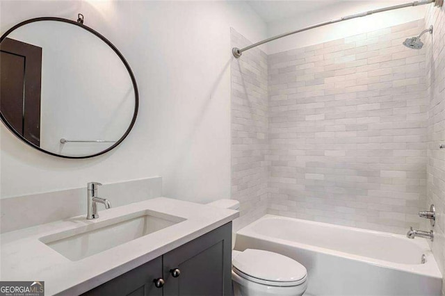 full bathroom featuring toilet, vanity, and tiled shower / bath combo