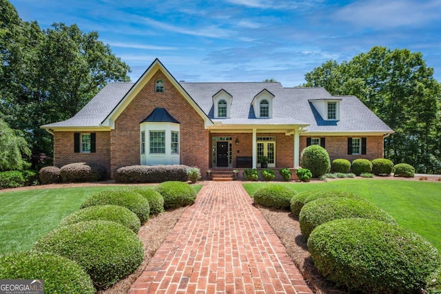 new england style home featuring a front lawn