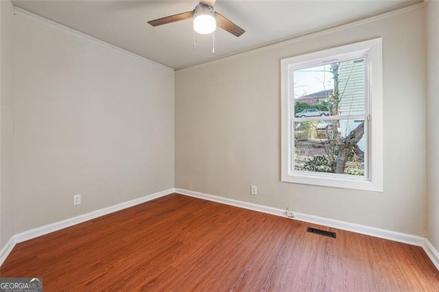 unfurnished room with ceiling fan, hardwood / wood-style floors, and ornamental molding