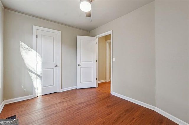 unfurnished bedroom with ceiling fan and hardwood / wood-style floors