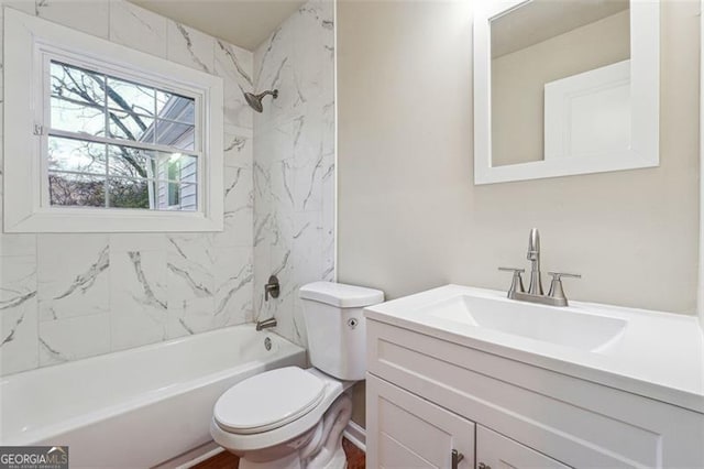 full bathroom featuring toilet, tiled shower / bath combo, and vanity