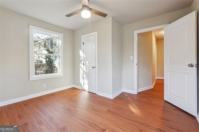 unfurnished bedroom featuring ceiling fan and hardwood / wood-style flooring