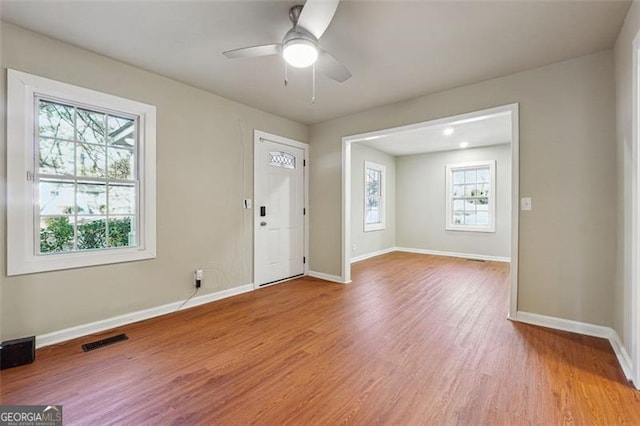 entryway featuring ceiling fan, hardwood / wood-style flooring, and a healthy amount of sunlight