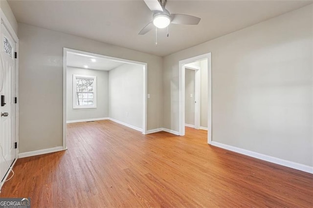 spare room featuring light hardwood / wood-style floors and ceiling fan